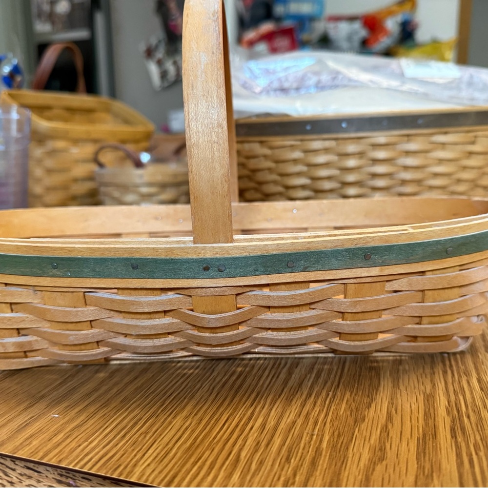 Warm brown signed oval Longaberger basket with handle and green trim